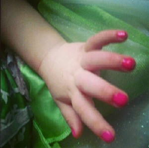 Pretty pink nails and a Tinkerbell dress.